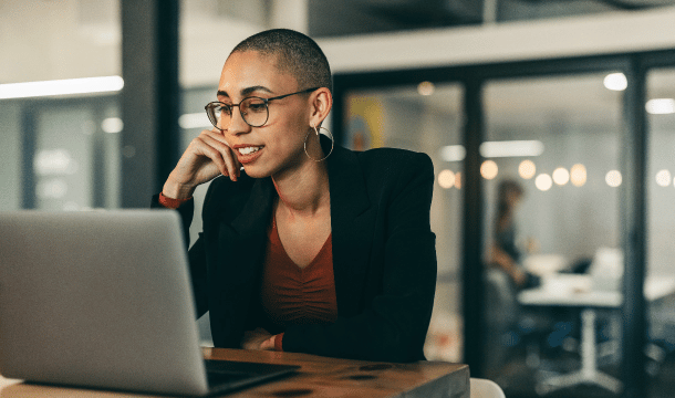 woman in an office setting looking at laptop